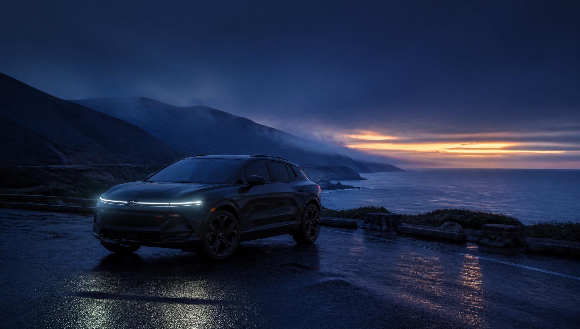 Luxury electric SUV on the California coast at dusk